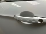 a close up of a door handle on a white car