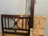 a wooden bed frame with a mirror on top of it