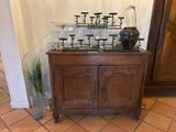 a wooden cabinet with candles on top of it