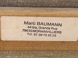the label on the back of a wooden bench reads marc baumann