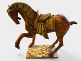 a statue of a horse with a saddle on it ' s back