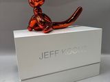 a statue of a cat sitting on top of a box