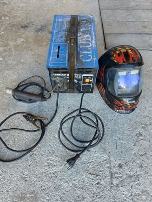 a helmet that is sitting on the ground next to a charger