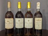 trois bouteilles de vin sont posées sur une table devant un mur