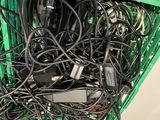 a pile of wires and cords in a green basket