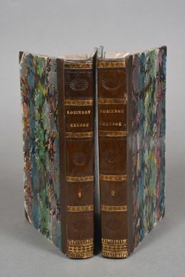 pair of antique bookends with floral designs on them on a gray surface
