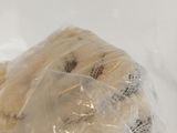 a piece of cake wrapped in plastic on a table