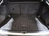 a trunk of a car with a black mat in the trunk