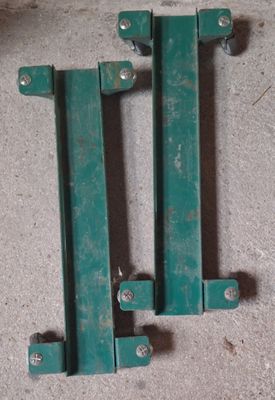 two pieces of green metal sitting on the floor