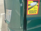 a green truck that has a sticker on the back of it