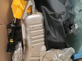 a pile of luggage and other items in a cardboard box