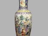 a vase with a painting on it sitting on a table