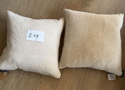 deux oreillers blancs posés l'un à côté de l'autre sur un parquet