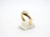 a close up of a gold ring on a white surface