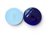 two blue glass buttons on a white surface with a white background