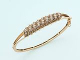 a close up of a gold bracelet with five diamonds on it