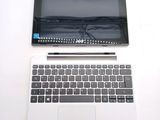 a laptop and a tablet on a white table