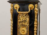 a black and gold clock sitting on a wooden table