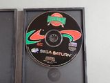 a cd in a black case with a green and red design