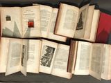 many open books sitting on top of a black table
