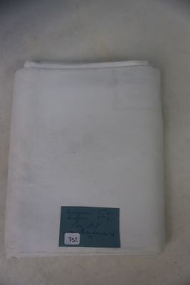 a white cloth with a blue label on it