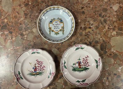 two plates and a bowl sitting on a table