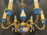 an image of a blue and gold chandelier hanging from a ceiling