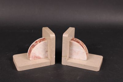pair of marble bookends on wooden bases with a black background