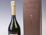 an open bottle of champagne sitting next to a cardboard box