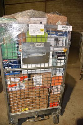 a metal cart with many items in it in a warehouse