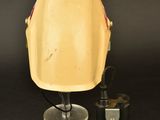 an image of a yellow helmet sitting on top of a table next to a canister