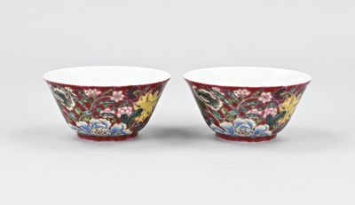 pair of red and white bowls with floral designs on them