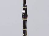 a close up of a bassoon on a clear acrylic stand