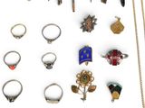 a lot of different rings and necklaces on a white surface