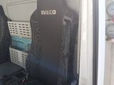 two seats in the back of a van with the seat covers down