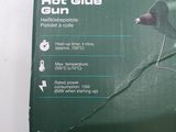 the box is open to show the contents of a hot glue gun