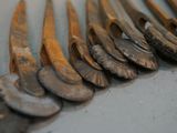 a lot of old silver spoons on a table