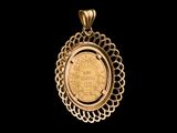 a close up of a gold coin in a pendant on a black background