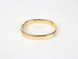 a close up of a gold ring on a white surface