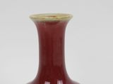 a red vase that is sitting on a table