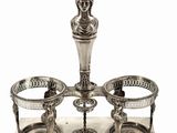 an image of a silver plate with three cups and a candle holder