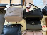 a lot of purses on a table in a store