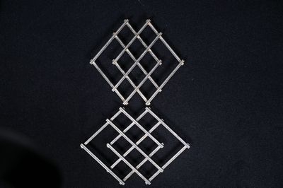 Dans le goût de Jacques ADNET. Deux dessous de plat en métal…