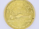 a gold coin with a picture of a plane on it