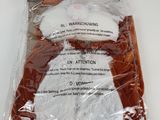a stuffed animal in a plastic bag on a table