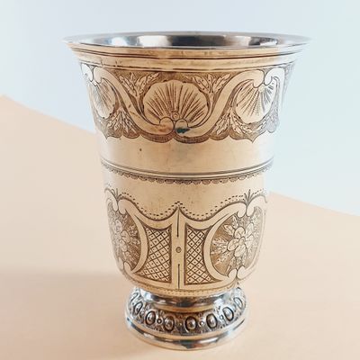a silver cup sitting on top of a table