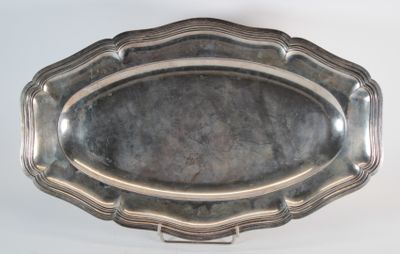 a silver tray with a silver handle on a white surface