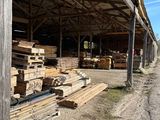 several stacks of wood are stacked up in a barn