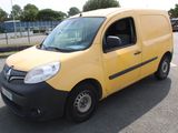 a yellow van that is parked in a parking lot
