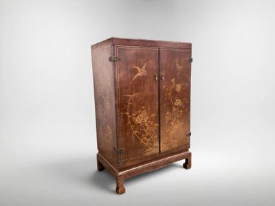 an old wooden cabinet with a floral design on it